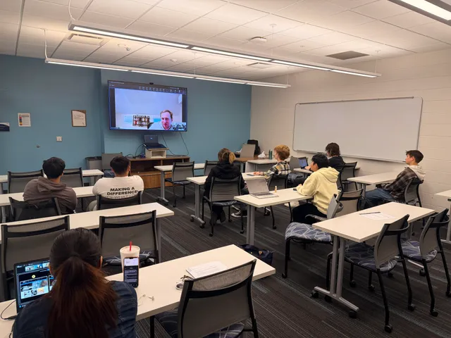 SISTA students listening to Drew Koechley on a classroom video call.